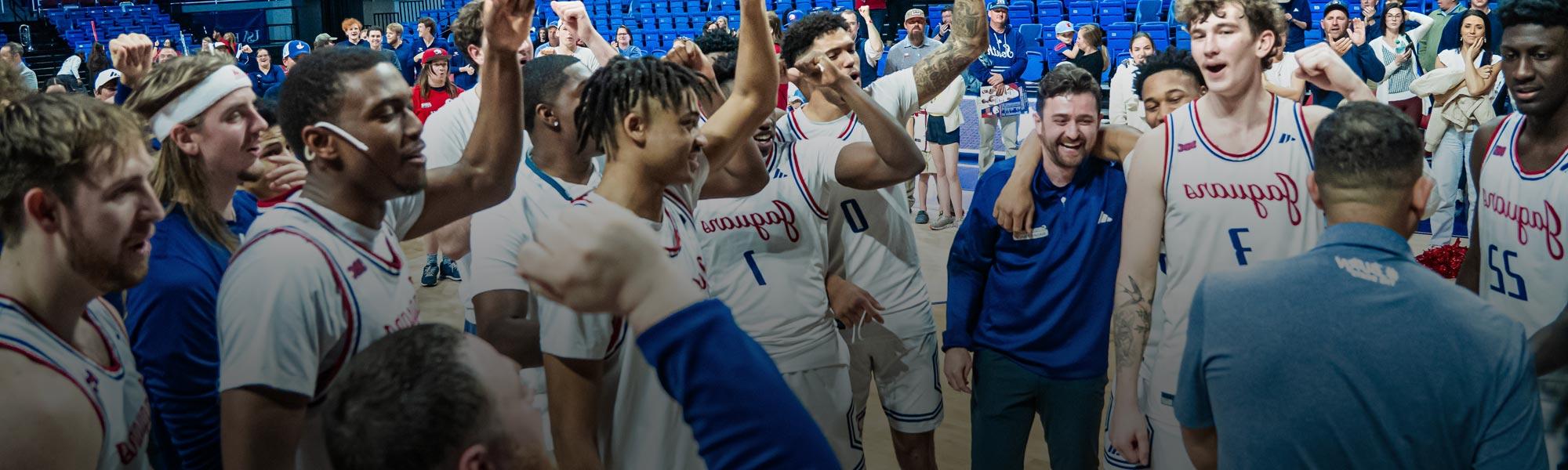 Men's basketball team celebrates after win